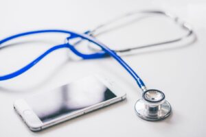 Smartphone beside a stethoscope, illustrating Indonesia's digital health platform Halodoc