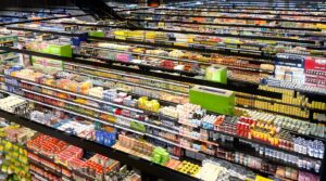 Brightly stocked supermarket aisles, illustrating Masan Group's WinMart grocery retail and branded consumer food business in Vietnam