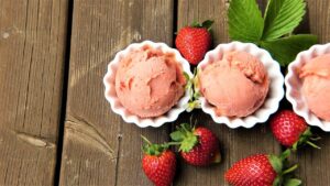 Bowls of fresh strawberry frozen yogurt topped with strawberries, similar to llaollao desserts sold by Woodpeckers Group in Malaysia