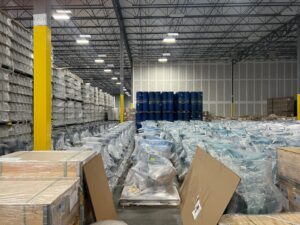 Warehouse stacked with goods wrapped in plastic stretch film, the type of packaging Thong Guan Industries manufactures