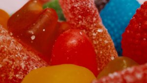 Close-up of colourful sugar-coated gummy candies and jelly sweets, illustrating Cocoaland's Lot 100 gummy business acquired by Fraser & Neave