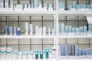 Rows of skincare products on white shelves in a beauty retail store, illustrating Sociolla's omnichannel beauty retail model in Indonesia
