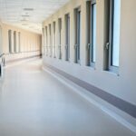 Bright, empty private hospital corridor with large windows and handrails, illustrating GIC's investment in Malaysian hospital operator Sunway Healthcare